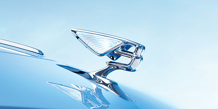 Bentley Al Khobar Bentley Flying Spur Azure sedan bonnet close up in Light Windsor Blue paint with Illuminated Flying B mascot