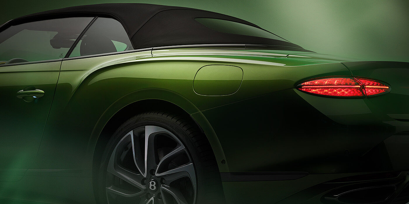 Bentley Al Khobar Bentley New Continental GTC Speed rear haunch and tail lamp in Tourmaline Green paint and dark tint brightware with black hood up and illuminated head lamps