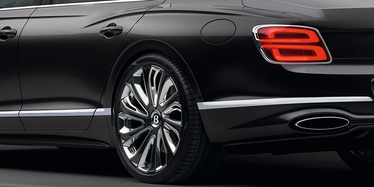 Bentley Al Khobar Bentley Flying Spur Mulliner sedan rear side exterior detail in Magnetic paint and 22 inch Mulliner painted and polished wheel