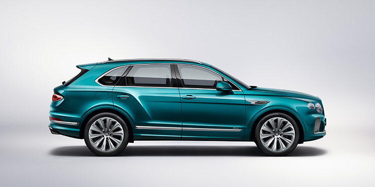 Bentley Al Khobar Bentley Bentayga Azure SUV in profile in Topaz blue paint featuring 22 inch 10 spoke directional wheels against a white background