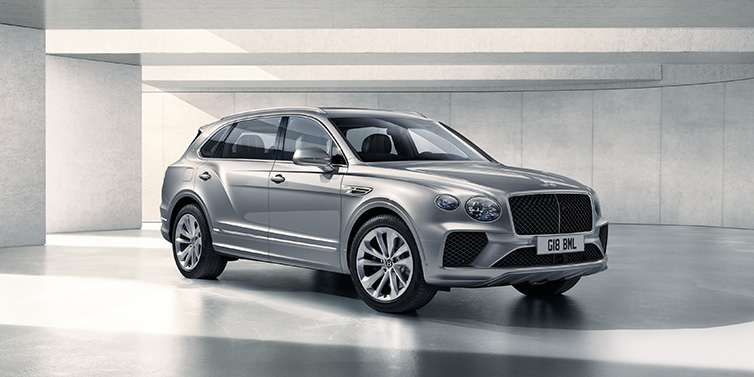 Bentley Al Khobar Bentley Bentayga Extended Wheelbase SUV front three quarter in Moonbeam paint with a grey background