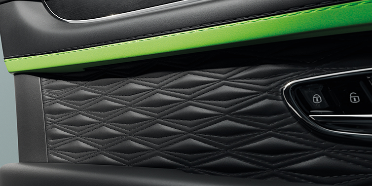 Bentley Al Khobar Bentley Bentayga Speed SUV interior door detail with Diamond in Diamond stitched hide in Beluga black colour, with Black stained Crown Cut Walnut veneer