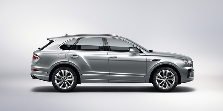 Bentley Al Khobar Bentley Bentayga SUV side profile in Moonbeam silver paint against white background featuring 21 inch 5 spoke wheels