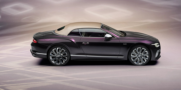 Bentley Al Khobar Bentley Continental GTC Mulliner convertible in profile with hood up, in Tanzanite Purple paint and 22 inch Mulliner painted and polished wheels