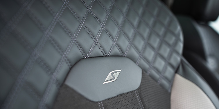 Bentley Al Khobar Bentley Bentayga S SUV rear interior seat detail with Beluga black hide and embroidered 'S' emblem