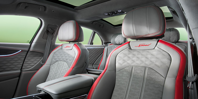 Bentley Al Khobar Bentley Flying Spur Speed sedan interior showing front and rear seats in Hotspur red and Gravity Grey hides, with Speed seat emblems