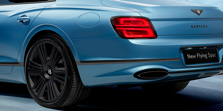 Bentley Al Khobar New Bentley Flying Spur Azure sedan in Light windsor blue by Mulliner paint and Black Specification, showing 22 inch Black Azure wheel, black exhaust pipes and exterior features