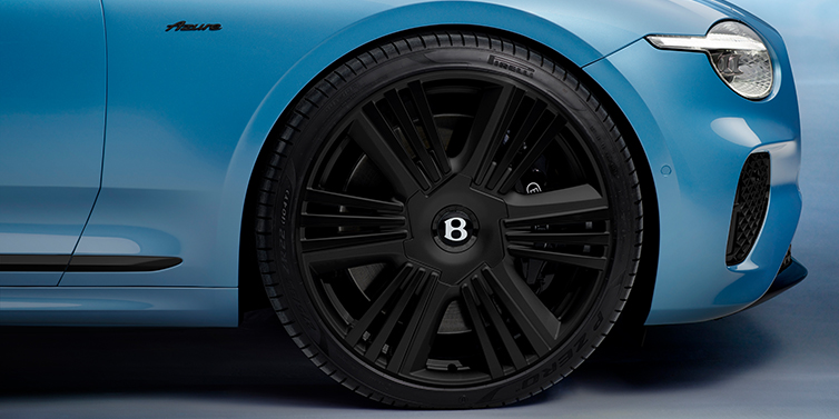 Bentley Al Khobar New Bentley Continental GTC Azure convertible front wheel detail with 22 inch black ten spoke wheel and dark chrome details against Light Windsor blue paint