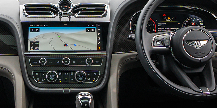 Bentley Al Khobar Bentley Bentayga S SUV front interior with right hand drive steering wheel and centre console with MMI screen showing driving directions