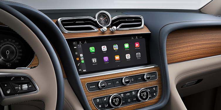 Bentley Al Khobar Bentley Bentayga Extended Wheelbase Azure SUV front interior centre console with MMI screen showing apps, surrounded by Portland and Imperial Blue coloured hides