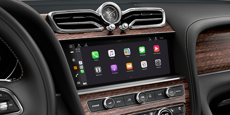 Bentley Al Khobar Bentley Bentayga Extended Wheelbase SUV front interior centre console MMI screen showing apps surrounded by Beluga black hide and Crown Cut Walnut veneer