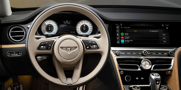 Bentley Al Khobar Bentley Flying Spur Mulliner sedan front interior detail of steering wheel and driver screens surrounded by Linen and Beluga black hides