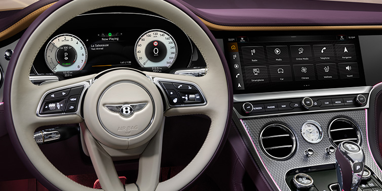 Bentley Al Khobar Bentley Continental GTC Mulliner convertible steering wheel and drivers screens surrounded by Damson purple and Linen hides